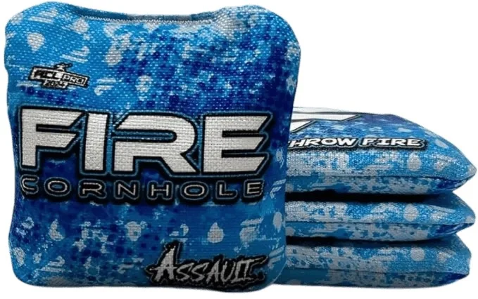 Set of Fire Cornhole bags from the Assault series, featuring a blue and white design with a speckled pattern. The text 'FIRE CORNHOLE' and 'Assault' is prominently displayed on the bags.