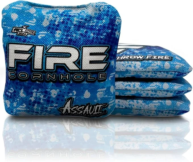 Set of Fire Cornhole bags from the Assault series, featuring a blue and white design with a speckled pattern. The text 'FIRE CORNHOLE' and 'Assault' is prominently displayed on the bags.