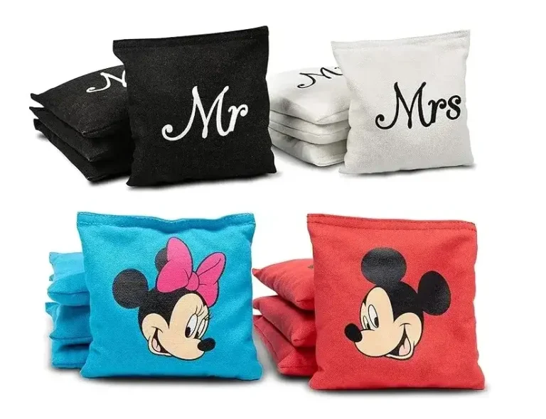 Custom cornhole bags featuring two themes: a black and white 'Mr' and 'Mrs' wedding set, and a Disney-themed set with blue Minnie Mouse bags and red Mickey Mouse bags. Ideal for adding a personal touch to cornhole games at weddings, parties, or family gatherings.