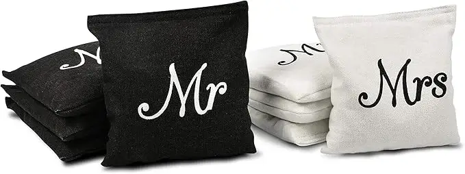 Wedding-themed cornhole bags with 'Mr' and 'Mrs' designs. The black bag displays 'Mr' in white text, and the white bag shows 'Mrs' in black text. Ideal for personalized cornhole games at weddings or special events.