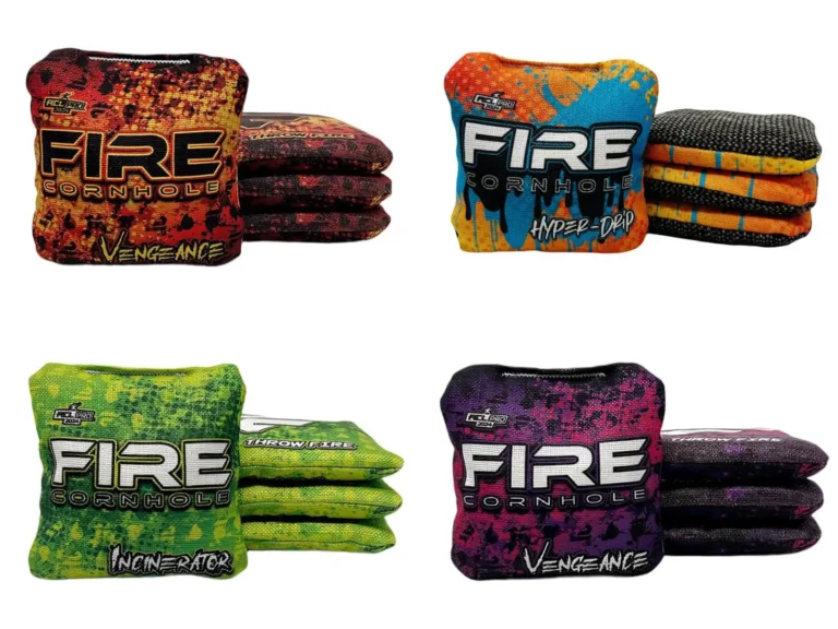 Four types of Fire Cornhole bags, each shown in stacks of four. Top left: Fire Vengeance bag with a red and black digital camo pattern. Top right: Fire Hyper-Drip bag with a bright blue and orange splatter design. Bottom left: Fire Incinerator bag featuring a green and yellow speckled pattern. Bottom right: Fire Vengeance bag in a purple and black digital camo design. All bags display the "Fire Cornhole" logo in bold white text