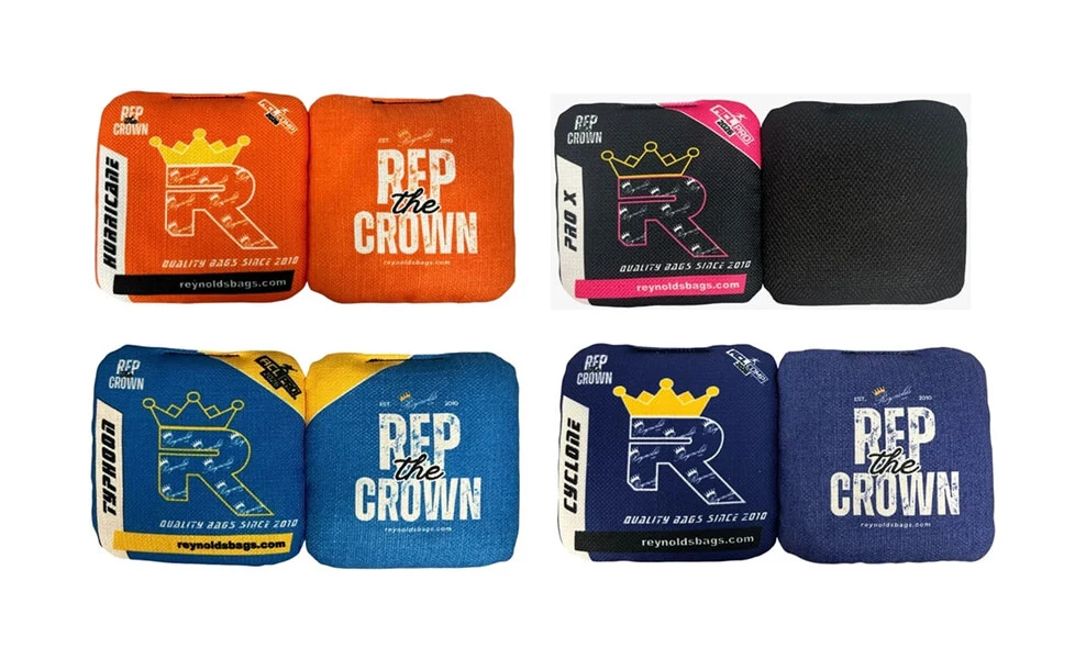 Reynolds Cornhole Bags in multiple designs and colors including Hurricane, Pro X, Typhoon, and Cyclone series, showcasing high-quality cornhole bags with Rep the Crown branding.
