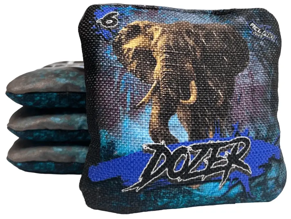 A set of Titan Cornhole bags from the Dozer series, featuring an elephant design with a dark blue and black background. The text 'DOZER' is boldly displayed on the bags along with a speed rating of 6 in the upper left corner.