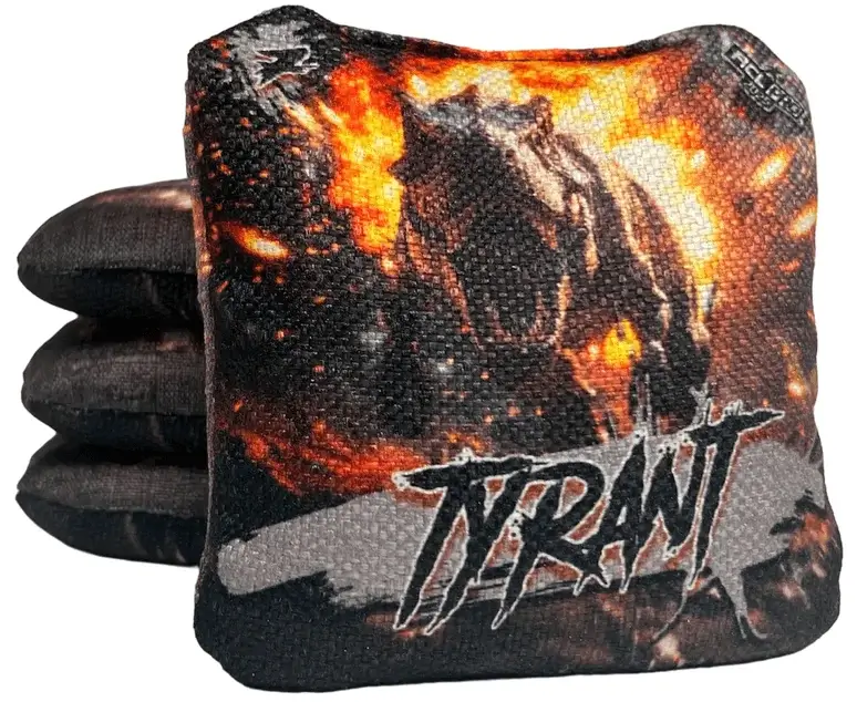 A set of Titan Cornhole bags from the Tyrant series, featuring a fierce T-Rex design with fiery orange and black tones in the background. The text 'TYRANT' is boldly displayed, with a speed rating of 7 shown in the upper left corner, representing its balanced and powerful play style.