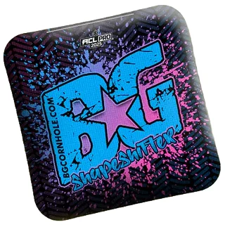 BG Shapeshifter cornhole bag featuring a vibrant design with splattered blue and pink colors, and the text 'BG Shapeshifter' in large bold font.