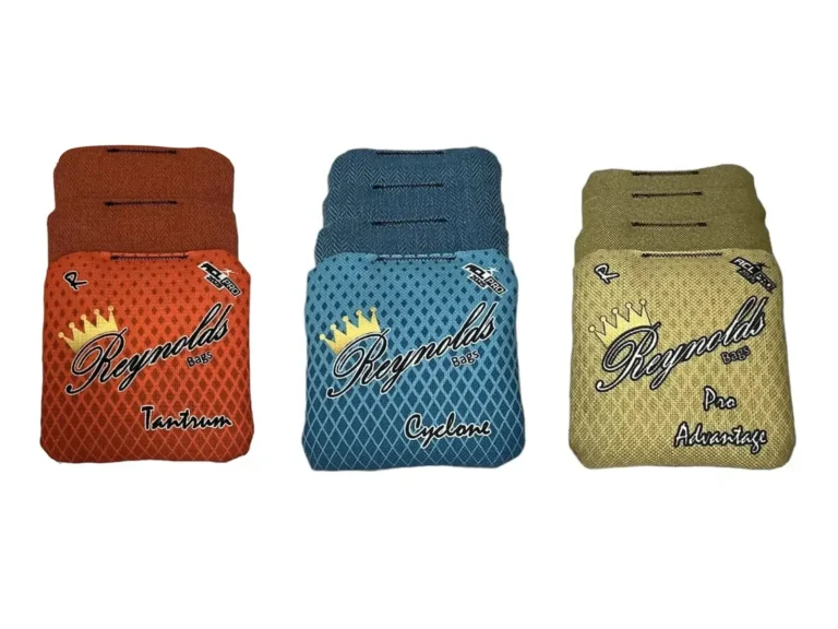 A display of three different Reynolds cornhole bags, each with unique designs and colors. Tantrum in orange, Cyclone in teal, Pro Advantage in gold, a popular bag for advanced players, These bags are designed for different playstyles, giving cornhole players a variety of performance options.