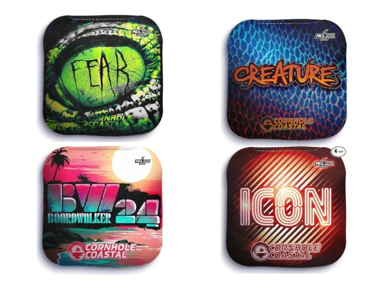 Four vibrant cornhole coastal bags featuring distinct designs: a green reptilian eye with the word 'FEAR,' a blue scaly pattern with 'CREATURES,' a tropical sunset theme labeled 'Boardwalker 24,' and a red-striped 'ICON' design. ACL Pro 2023 branding is visible on all bags.