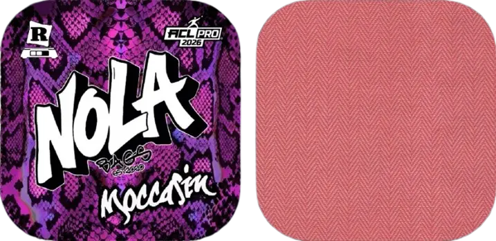 A duo of Nola Bags Cornhole bags. The left bag features a vivid purple and black snakeskin pattern as its background. On top of this, "NOLA" is written in large white graffiti-style letters with "Moccasin" in white script below. A small "R" logo is in the top left corner, and "ACL PRO 2026" is in the top right. The right bag is a solid, warm salmon pink color with a subtle diagonal textured pattern.