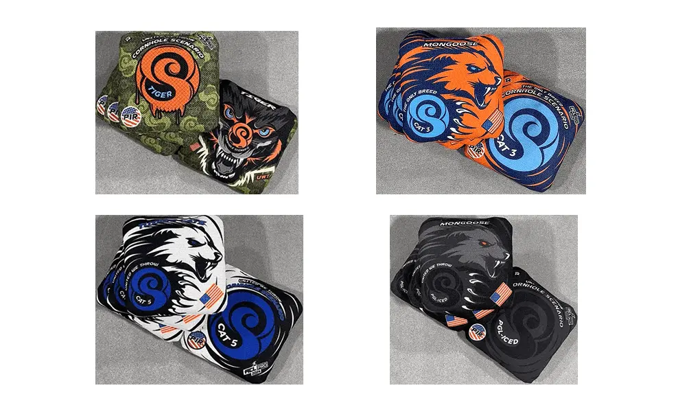 A grid of four images, each showing two cornhole bags on a gray surface. Top left: Green camouflage bags with an orange tiger head and an orange "S" logo. Top right: Orange and blue bags with an orange mongoose head and a blue "S" logo. Bottom left: Black and white bags with a white tiger head and a blue "S" logo. Bottom right: Black bags with a gray mongoose head and a gray "S" logo.