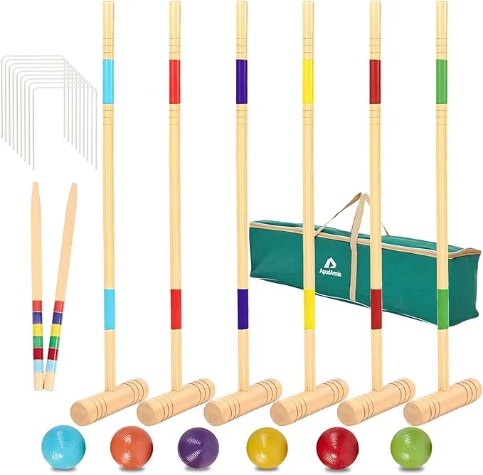 
Model
A croquet set is neatly arranged, featuring six wooden mallets with color-banded handles (blue, orange, purple, yellow, red, and green). Each mallet has a natural wood head and a long wooden shaft. Six matching colored balls are placed in front of their respective mallets. To the left, a set of white wire wickets are stacked, and two wooden stakes with colorful bands are visible. In the background, a green carrying bag for the set is partially visible.