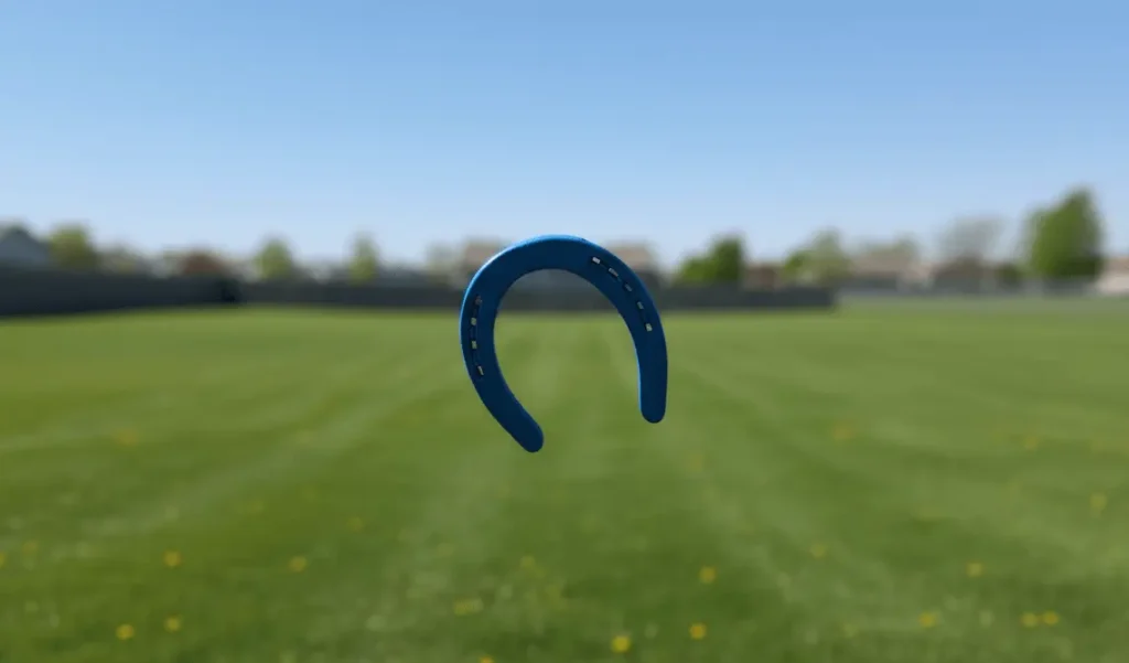 Horseshoe in mid air flying toward stake target, outdoor throw action, blue sky background, sports motion photograph